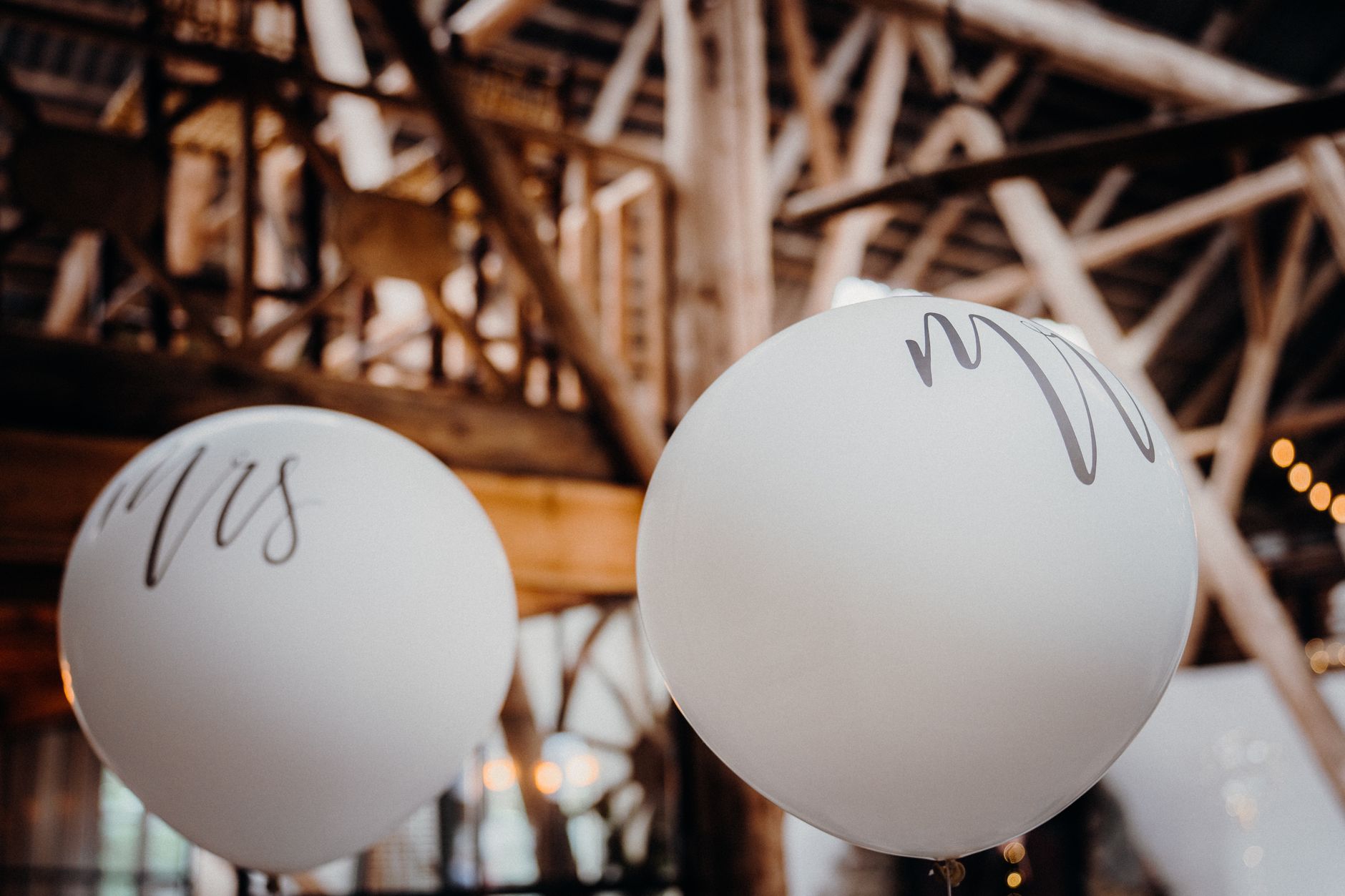 White wedding balloons in rustic venue